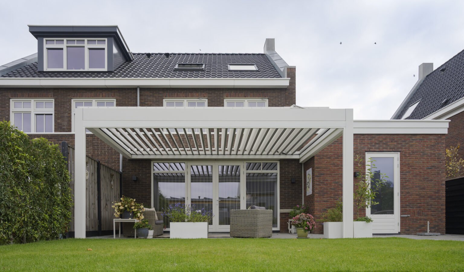 Bioclimatic louvered pergola on a garden terrace